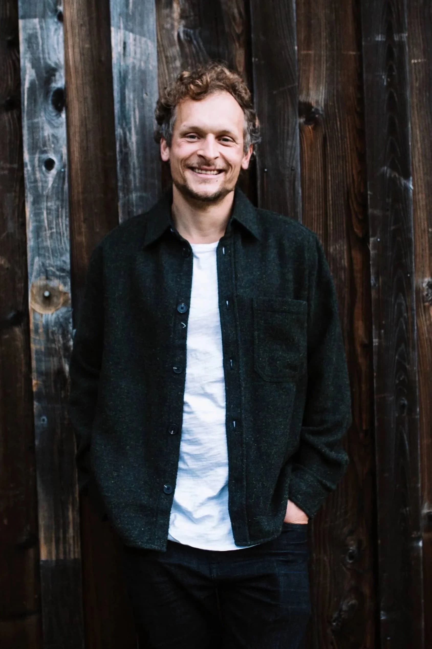 Dr. Kefferputz smiling in front of a rustic barn